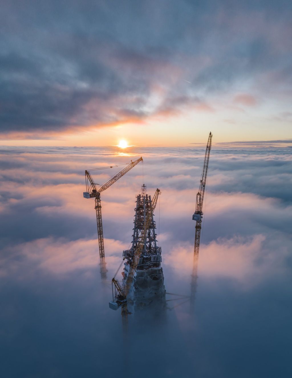 sunset above skyscraper by mikhail proskalov